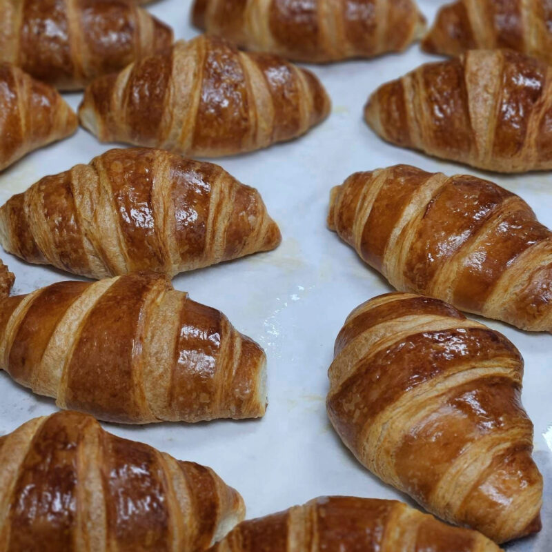 freshly baked croissants on a baking sheet