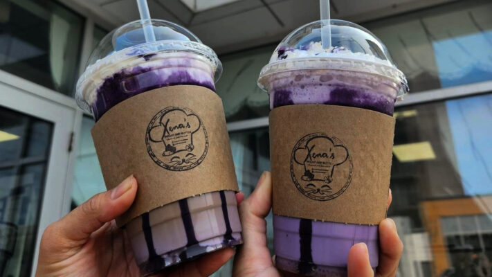 two people holding up purple ube frappes